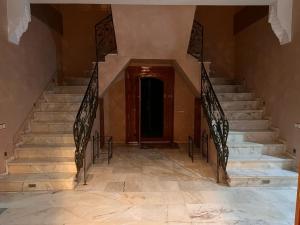 a staircase in a building with a door and stairsngthngthngthngthngthngth at villa OUSSAMA in Marrakech