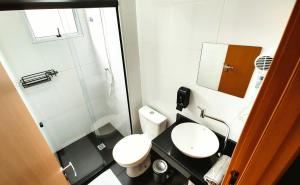 a small bathroom with a toilet and a sink at Apto Executivo Ravena in Campo Grande