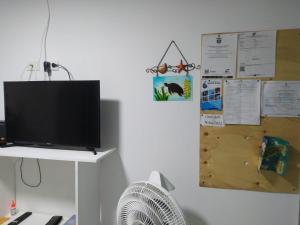 a room with a tv on a wall with a fan at Apartamentos AJ place 2 in San Andrés