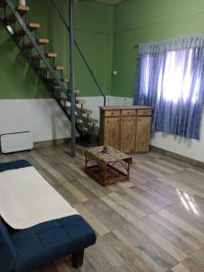 a room with a staircase and a bench and a table at Alquiler temporario Mendoza in Las Heras