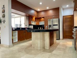 a large kitchen with wooden cabinets and a black counter top at Guerrero 318 in Puerto Vallarta