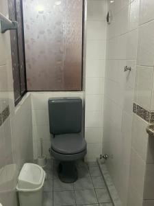 a small bathroom with a toilet and a shower at Belle Ville Tarapaca in Sucre