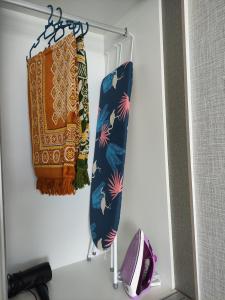 a closet with two ties hanging on a door at 7INN Evo Soho Bangi (Free Parking, WIFI, Netflix) in Bandar Baru Bangi