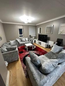 a living room with two couches and a television at A 2 standard bedrooms flat in London