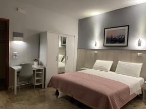 a bedroom with a bed and a desk and a table at 216 Venice in Mestre