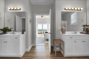 a white bathroom with two sinks and a mirror at Hang Zen - Beachfront Luxury 6 BR Hot Tub, Elevator in North Topsail Beach +37 photos