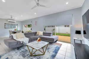 a living room with a couch and a table at The OC Home: Centrally Located, Home Away Home in Nightcliff