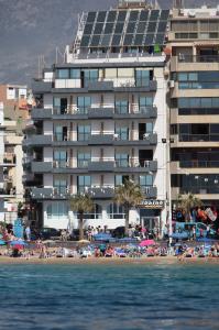 
a large body of water with buildings and people at Hotel Bilbaino in Benidorm
