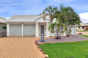 a house with palm trees in front of a driveway at The OC Home: Centrally Located, Home Away Home in Nightcliff