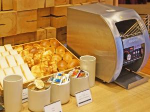 a table with a tray of pastries and a toaster at Chisun Grand Takayama in Takayama