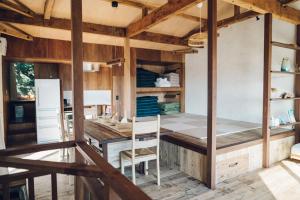 a kitchen with a table and chairs in a room at Villa Yumigahama in Minamiizu