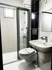 a bathroom with a toilet and a sink and a shower at Kestanbol Hotel in Canakkale