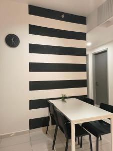 a dining room with a black and white stripe wall at Beacon Executive Suites - By IZ in George Town