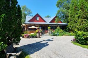 a house with a red roof and a driveway at Peaceful & Private Cabin close to the Lake in Matlock