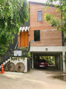 a building with a car parked in a garage at Dawnthaya Ayutthaya House in Phra Nakhon Si Ayutthaya