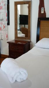a hotel room with a bed and a mirror at Choby's House Holbox in Holbox Island