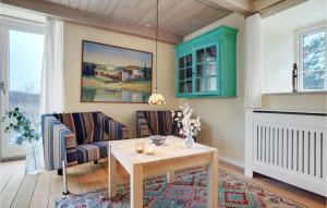 a living room with a table and chairs at Gorgeous Home In Glesborg With Wifi in Glesborg