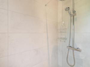 a bathroom with a shower with a shower head at Uk43576 - Bramble Cottage in Begelly