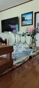 a group of wine glasses sitting on a table at Casa Lora, camino a las playas. in Puerto Jiménez