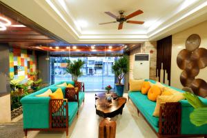 a living room with two couches and a table at Happy Life Green Hotel in Ho Chi Minh City
