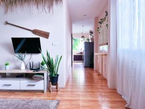 a hallway with a desk and a tv on a wall at Sea Dreamer Beachfront Apartments in Phuket Town