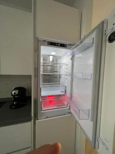 an empty refrigerator with its door open in a kitchen at Kasia porta sul mare di Livorno Free parking in Livorno