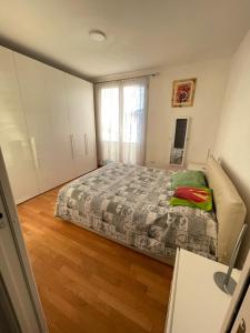 1 dormitorio con 1 cama y suelo de madera en Kasia porta sul mare di Livorno Free parking, en Livorno