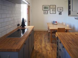 cocina con fregadero y mesa de madera en Grey Croft, en Christon Bank