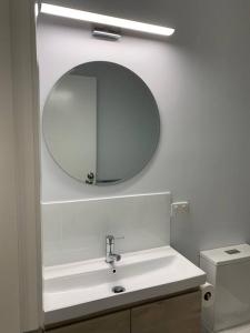 a bathroom with a sink and a mirror on the wall at Fern3BnB in Denmark