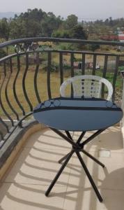 a blue chair sitting on top of a balcony at Spacious and Serene 1 bedroom apartments with a lake view and town view in Nakuru