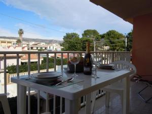 - une table avec une bouteille de vin et des verres sur un balcon dans l'établissement Tonnara apartment 1st floor codi facing the sea with view - wi-fi, à Avola