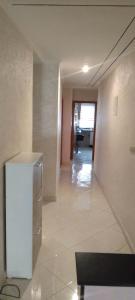 an empty hallway with a refrigerator in a building at مسكن الراحة in Tafza