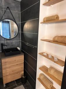 a bathroom with a sink and a mirror at Studio chic jacuzzi in Portet-sur-Garonne