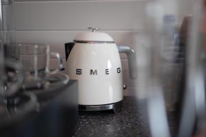 a white tea kettle sitting on a counter at Endrick Escape - Luxury Glamping 