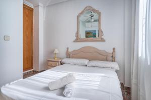 two beds in a bedroom with a mirror on the wall at Espanhouse Playa Townhouse in La Zenia close to the beach in Orihuela +41 photos