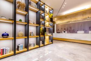 a library with shelves of books at Tuke China Hotel -Wenzhou South Bus Terminal in Wenzhou