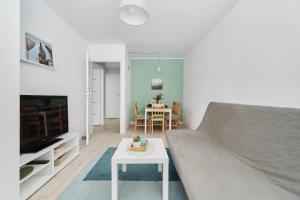 a living room with a couch and a table at Charming Family Apartment in Wroclaw by Renters in Wrocław