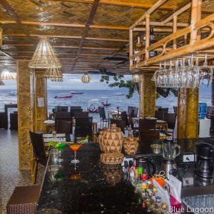 a dining room with a view of the ocean at Blue Lagoon Guest house for Backpakers in Puerto Galera