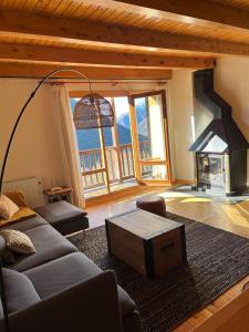 a living room with a couch and a fireplace at Boí Taüll CALMA DÚPLEX in Taüll