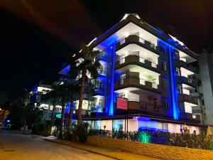 a building with blue lights on it at night at Alanya Risus Park Hotel in Alanya