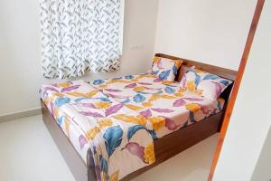 un letto con piumone floreale in camera di Servostay Fully Furnished 2 BHK in Hafeezpet #102 a Hyderabad