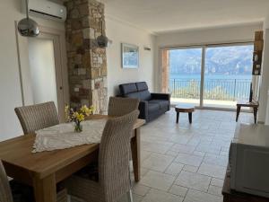 a living room with a table and a couch at MonyStelly in Cà Romana in Brenzone sul Garda