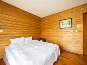 Postel nebo postele na pokoji v ubytování Bishui Shanju Lakeside B&B