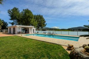 a swimming pool in a yard with a house at Can Maruna in Sant Joan de Labritja