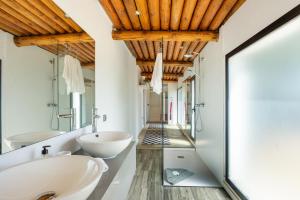 a bathroom with two sinks and a mirror at Can Maruna in Sant Joan de Labritja +16 photos