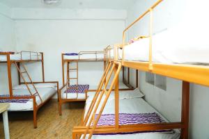 a room with two bunk beds in a dorm room at Royal Coorg Guest house in Madikeri