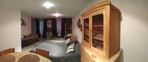 a room with a bed and a cabinet with wine bottles at Appartement Loft Grenouillit Le Puy en Velay in Le Puy-en-Velay