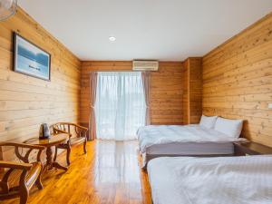 Postel nebo postele na pokoji v ubytování Bishui Shanju Lakeside B&B