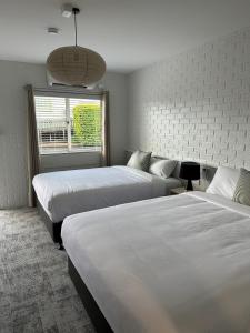 a hotel room with two beds and a window at The Shamrock Hotel in Toowoomba