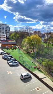 a parking lot with cars parked in a park at STEFI ' s Apartament in Sibiu +9 photos
